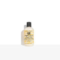 Hair conditioner bottle with black cap, white bottle and yellow label text