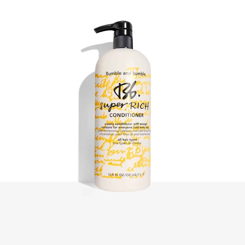 Hair conditioner bottle with black pump, white bottle and yellow script label