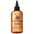 Bond-building hair flash rinse bottle with amber liquid and black nozzle cap