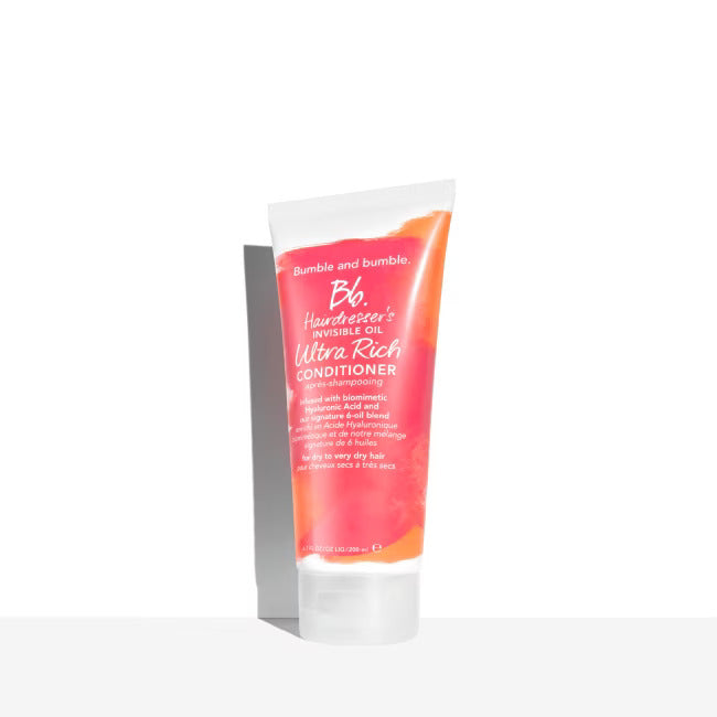 Bumble and Bumble ultra-rich conditioner tube, orange-pink with white cap