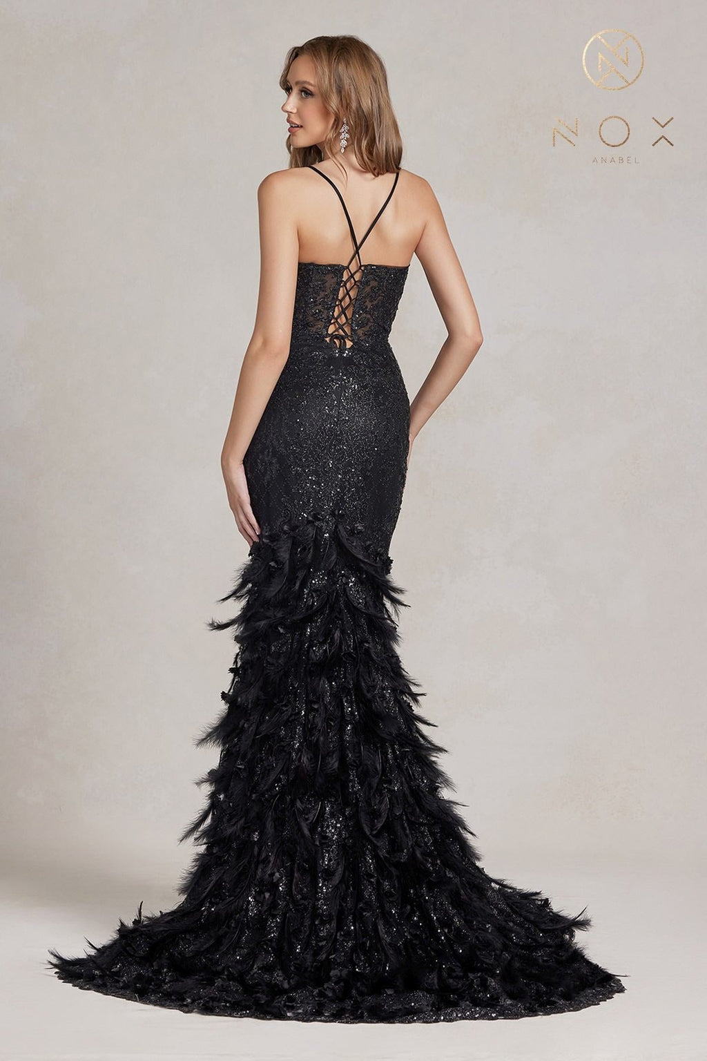 Black glitter mermaid gown with crisscross back straps and feather ruffle skirt