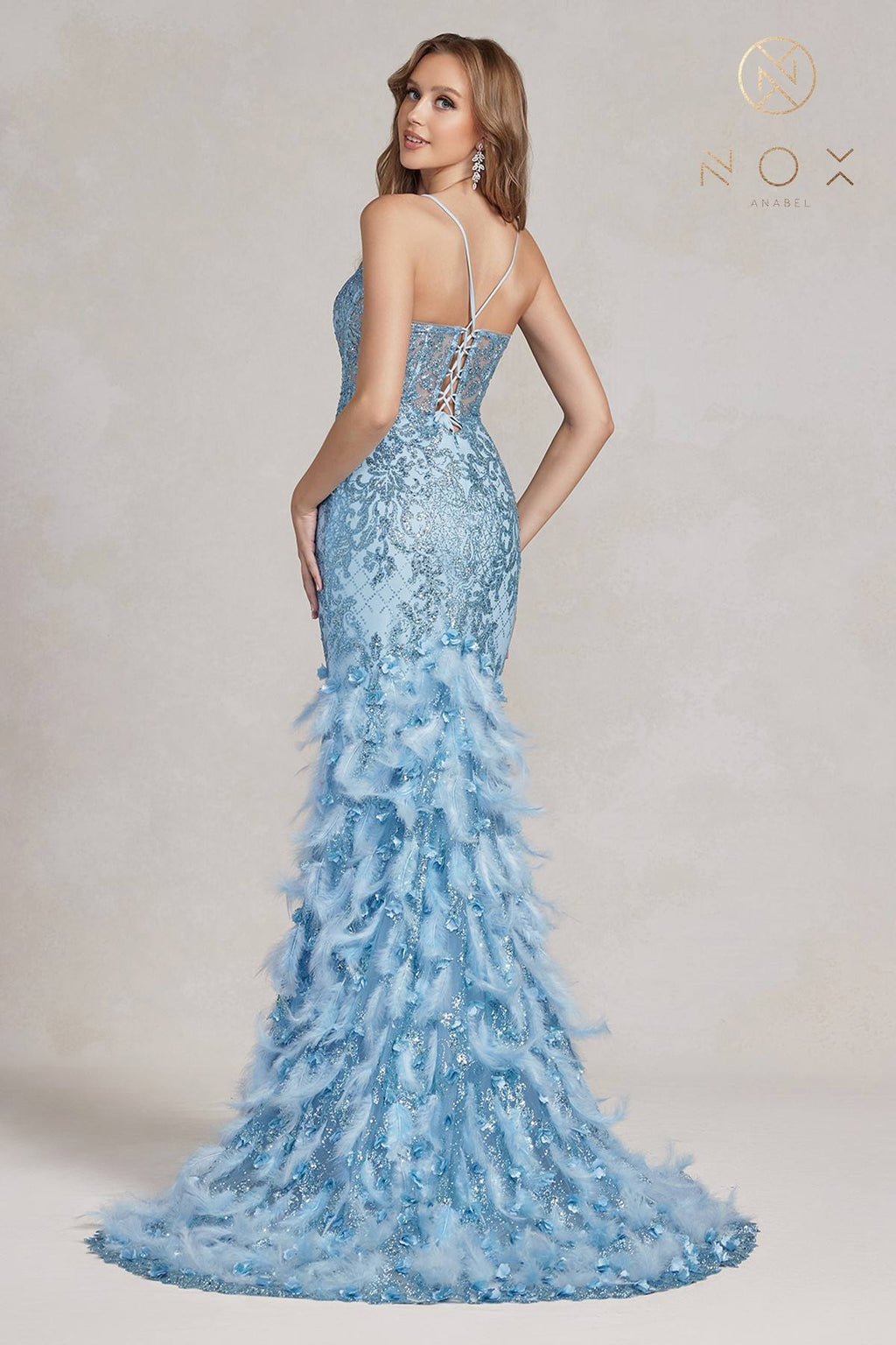 Light blue glitter mermaid gown with crisscross back straps and feather ruffle hem