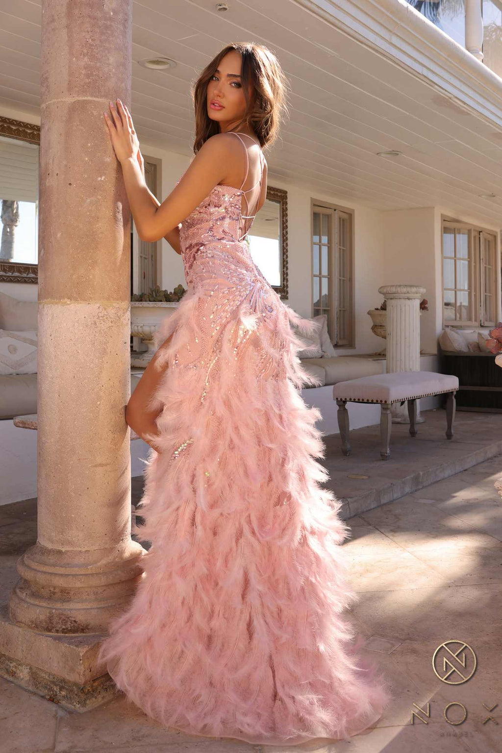 Champagne sequin gown with layered feather skirt and thigh slit