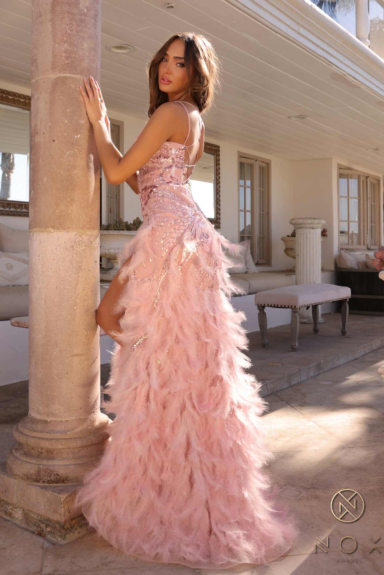 Champagne sequin gown with layered feather skirt and thigh slit