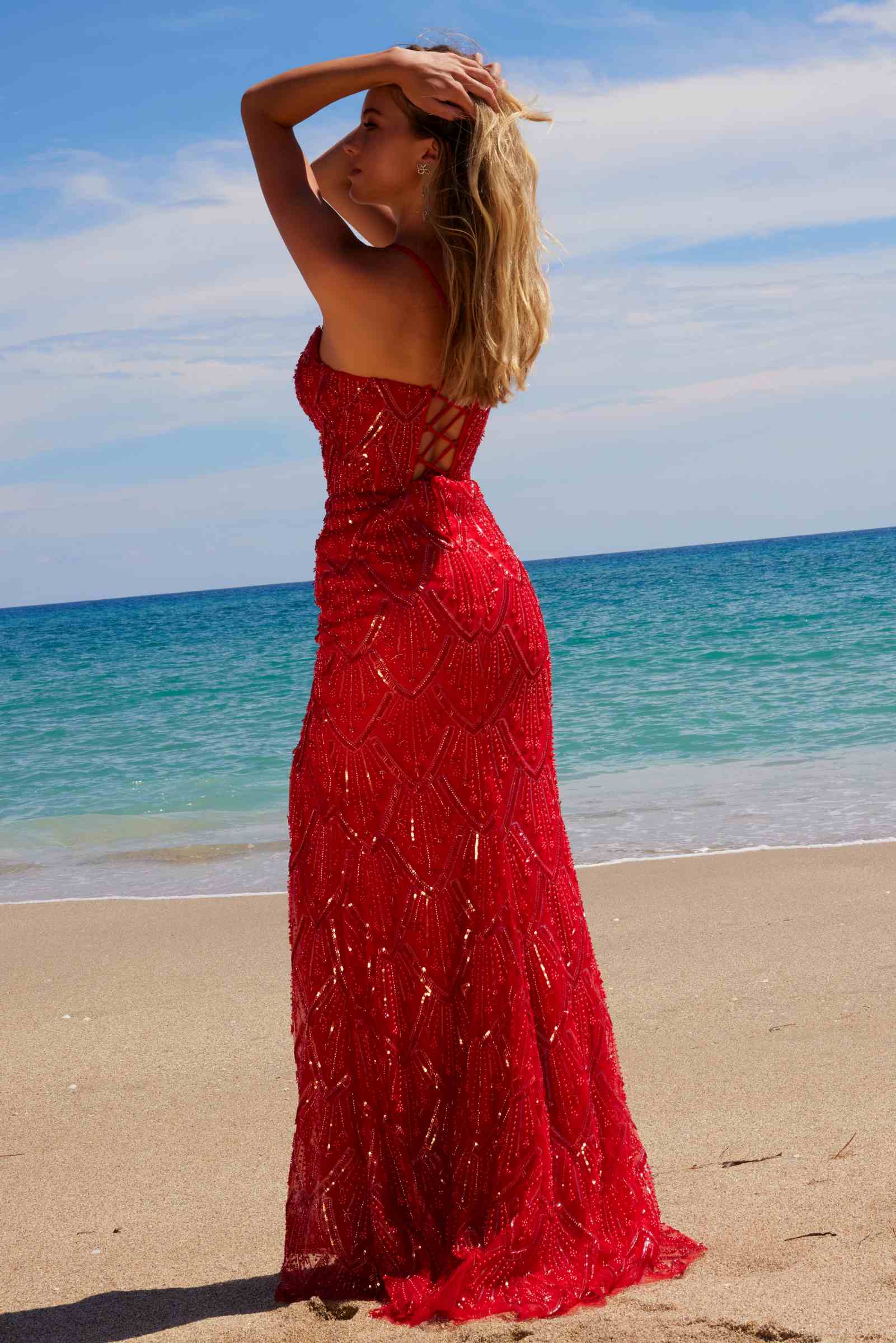 Red beaded tulle lace-up dress with side slit and V-back straps, angled view