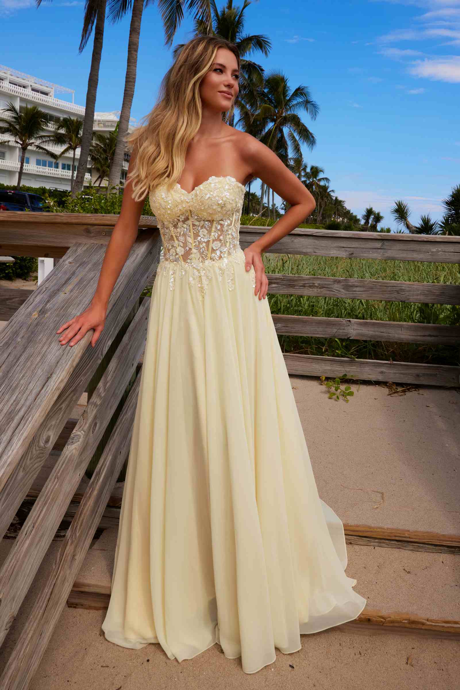 Lemon strapless corset dress with lace applique bodice and flowing chiffon maxi skirt, angle view