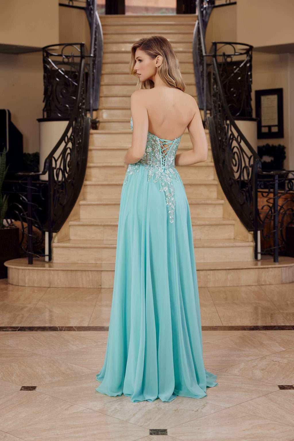 Sage green strapless corset dress with lace applique back and flowing chiffon maxi skirt, back view