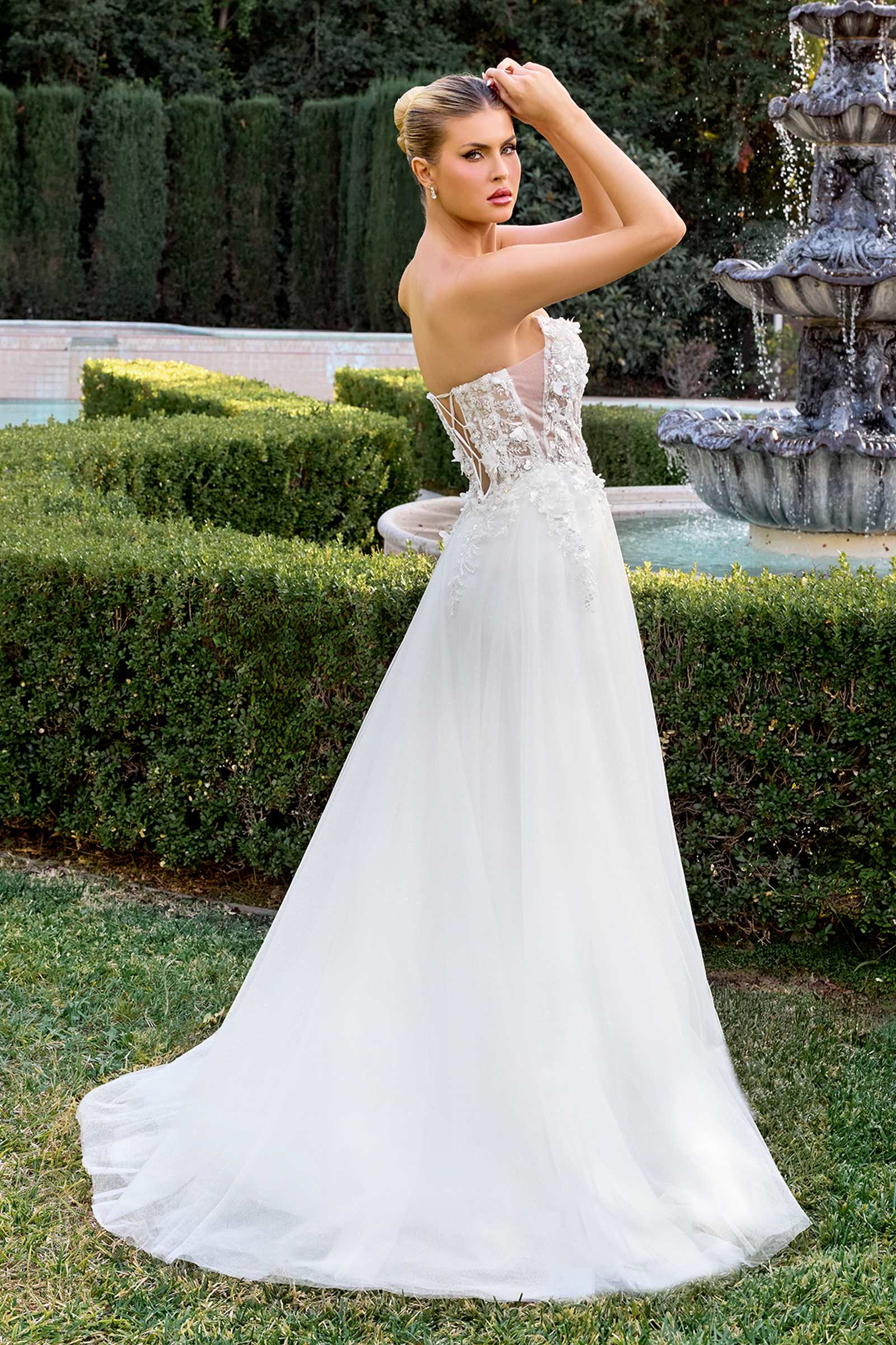 Off-white strapless gown with lace corset bodice and A-line tulle skirt, side view