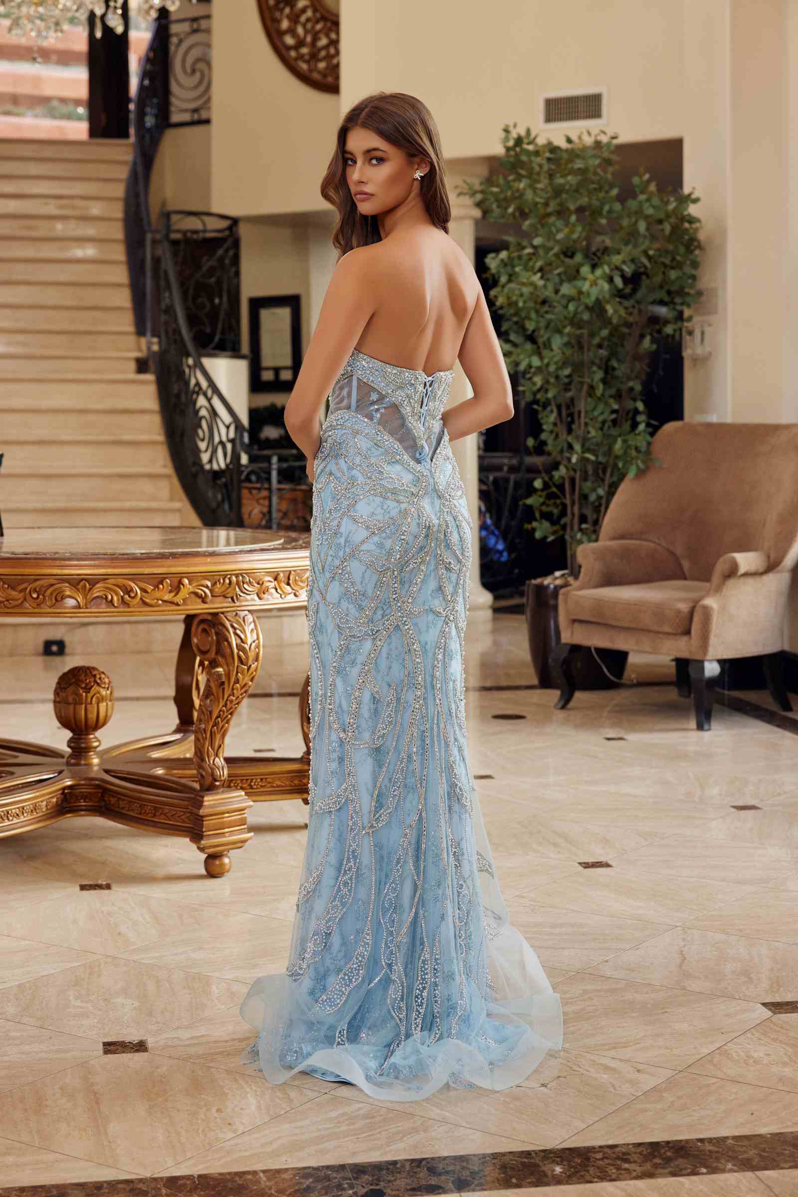 Light blue beaded fitted prom gown with peaked neckline and open back, mermaid silhouette