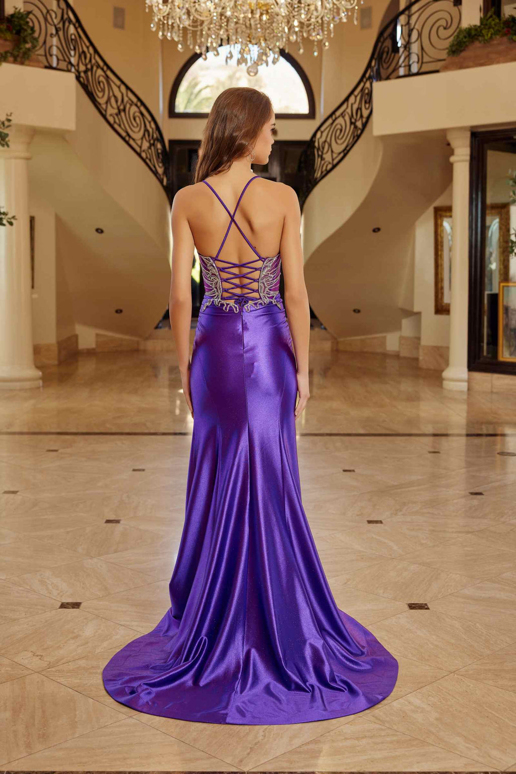 Back view purple fitted shimmer prom gown with cross-back straps and rhinestone trim