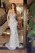 Silver strapless beaded prom gown with peaked neckline and fitted bodice, flowing skirt