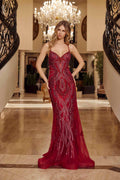Burgundy beaded tulle prom gown with spaghetti straps and fitted mermaid skirt