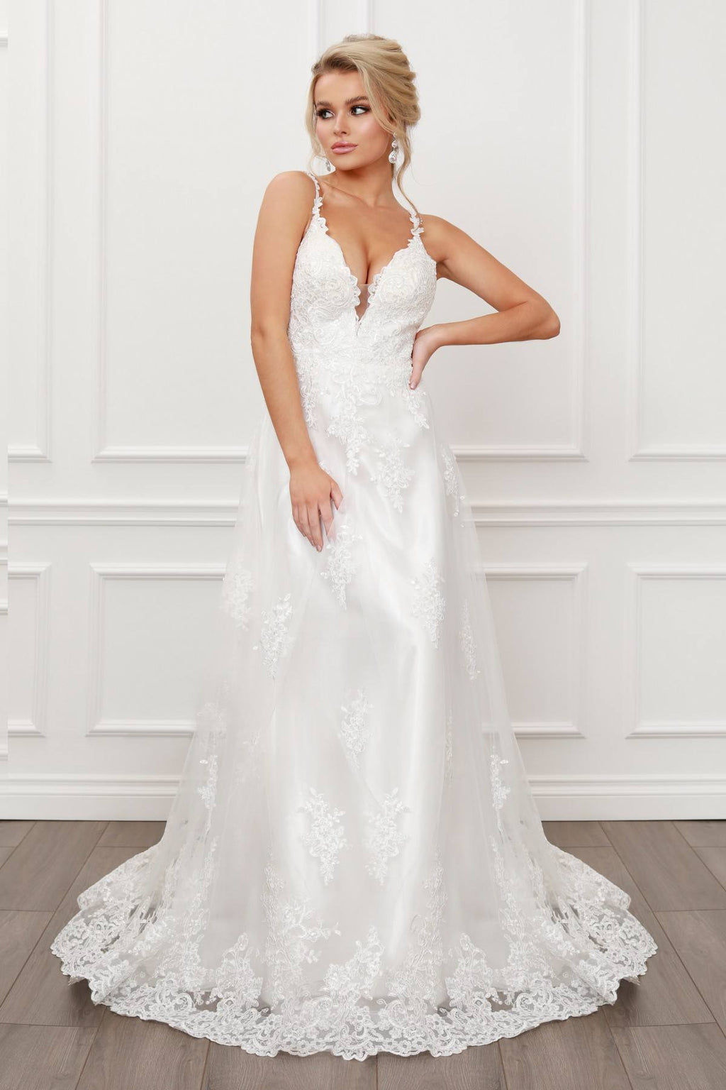 White lace A-line ball gown with V-neck and lace straps, full length skirt.