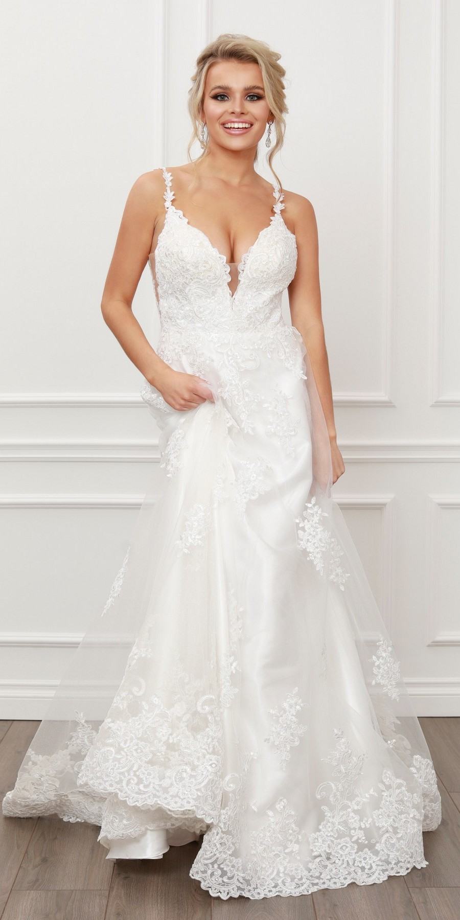 White lace A-line ball gown with V-neck, lace straps, and sheer tulle skirt.