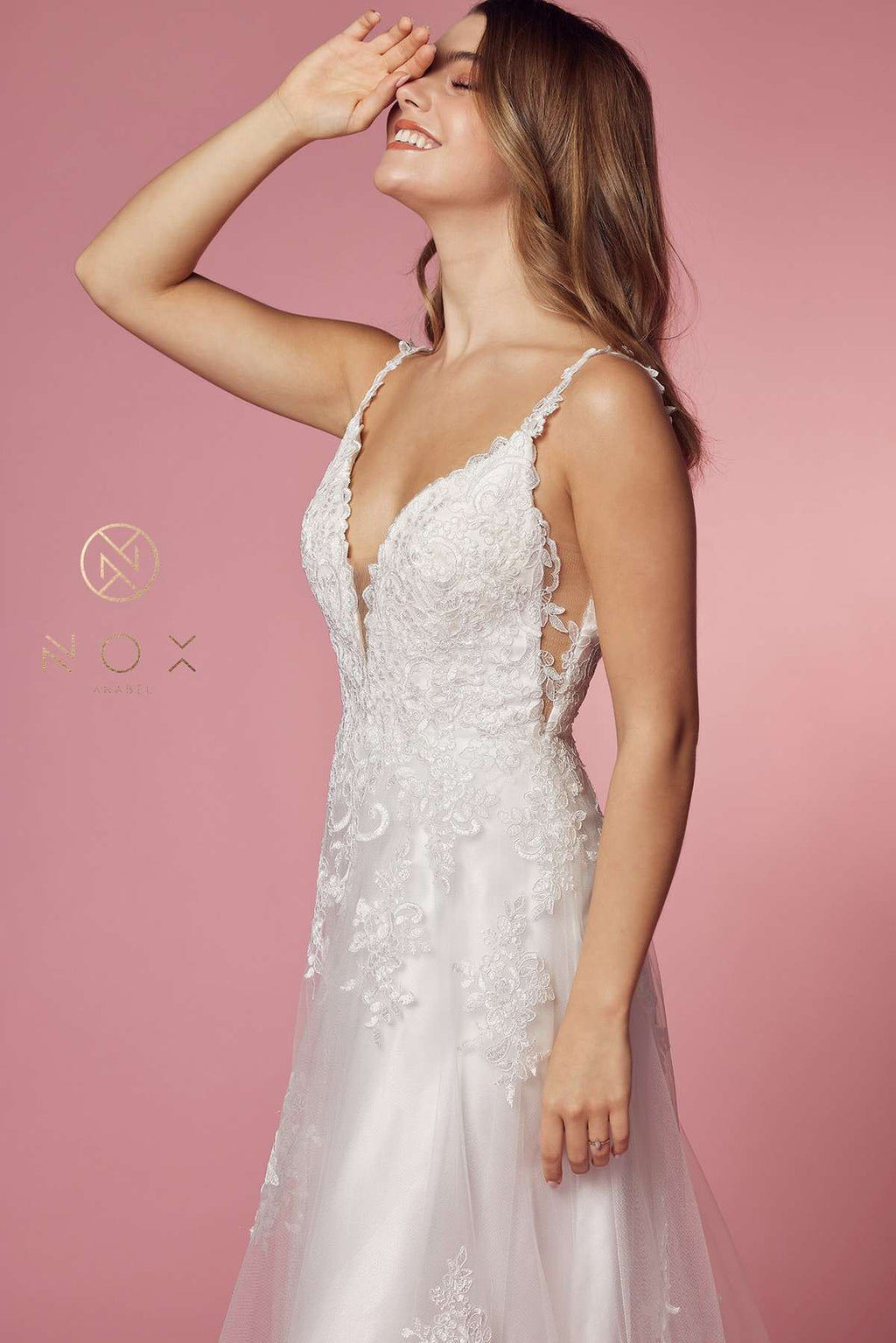 White lace V-neck ball gown with thin lace straps and open back panel detail.