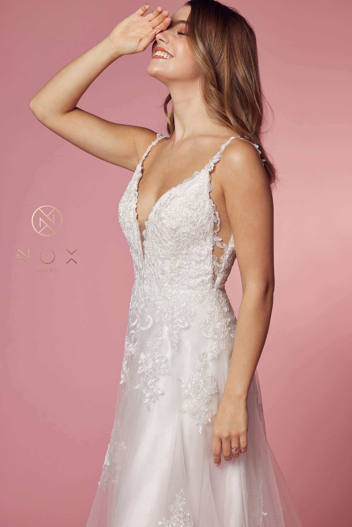 White lace V-neck ball gown with thin lace straps and open back panel detail.