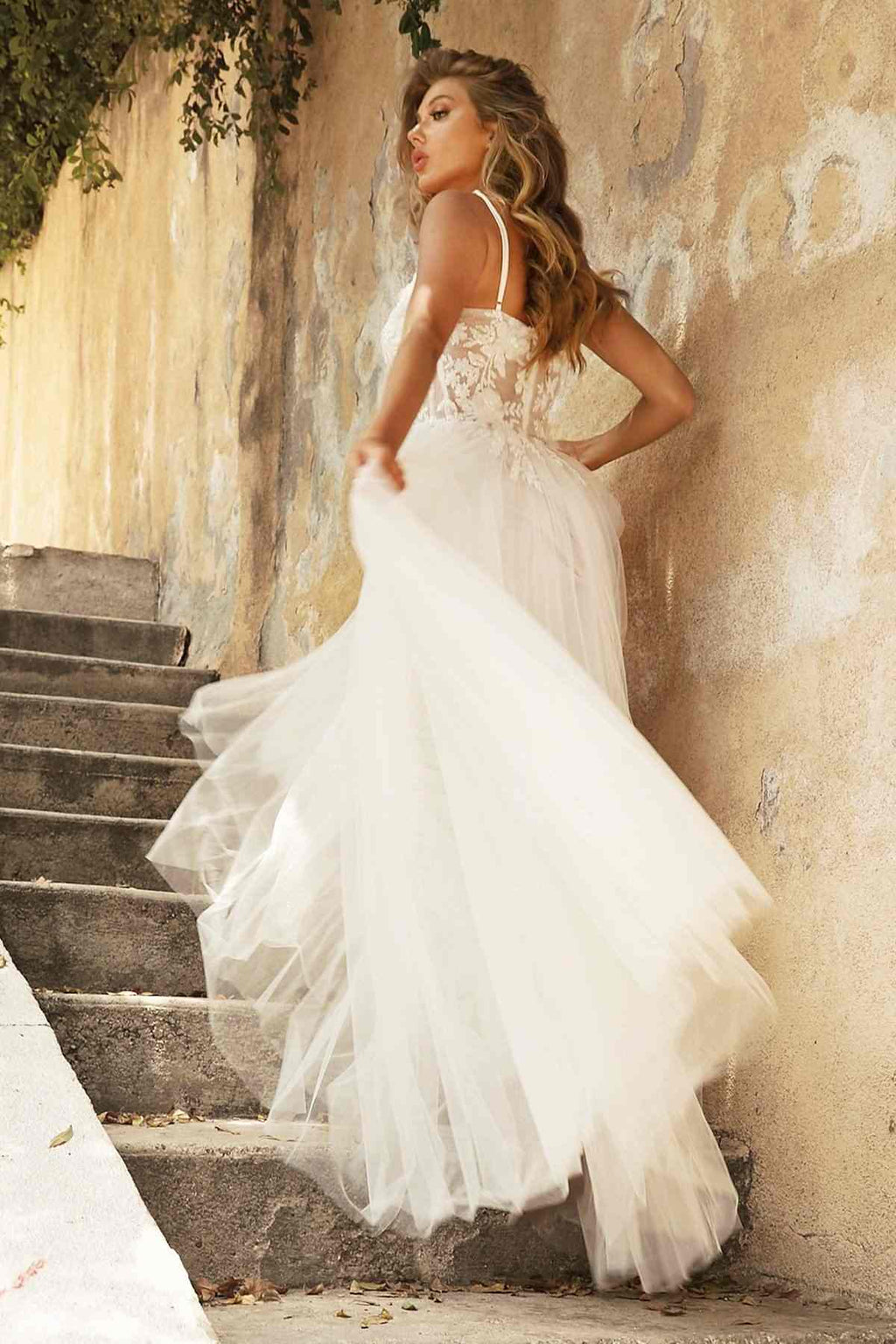 Off-white layered tulle bridal gown with embroidered bodice and full A-line skirt