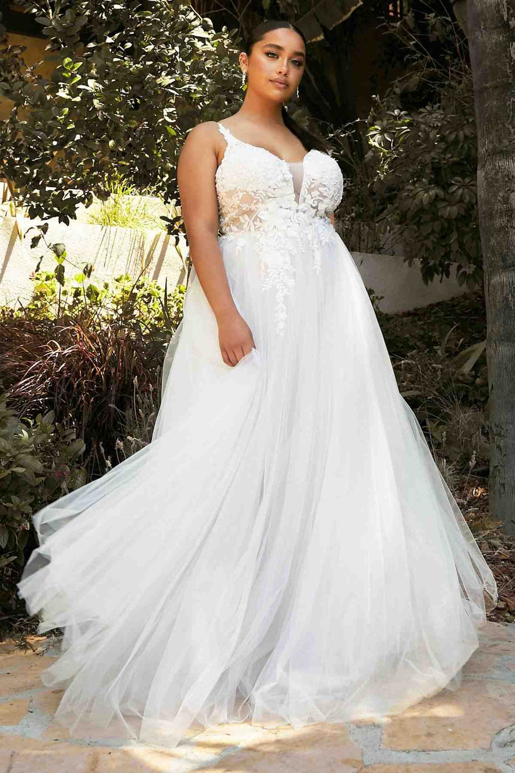 Off-white A-line tulle bridal gown with textured embroidered bodice and layered skirt