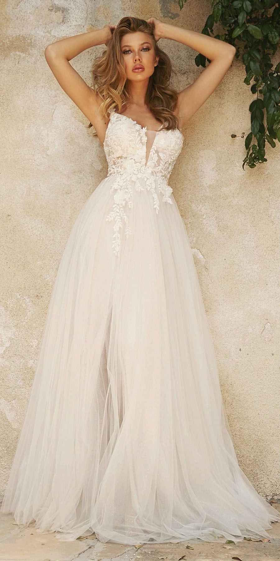 Off-white layered tulle A-line bridal gown with lace appliqué embroidered bodice and sheer skirt