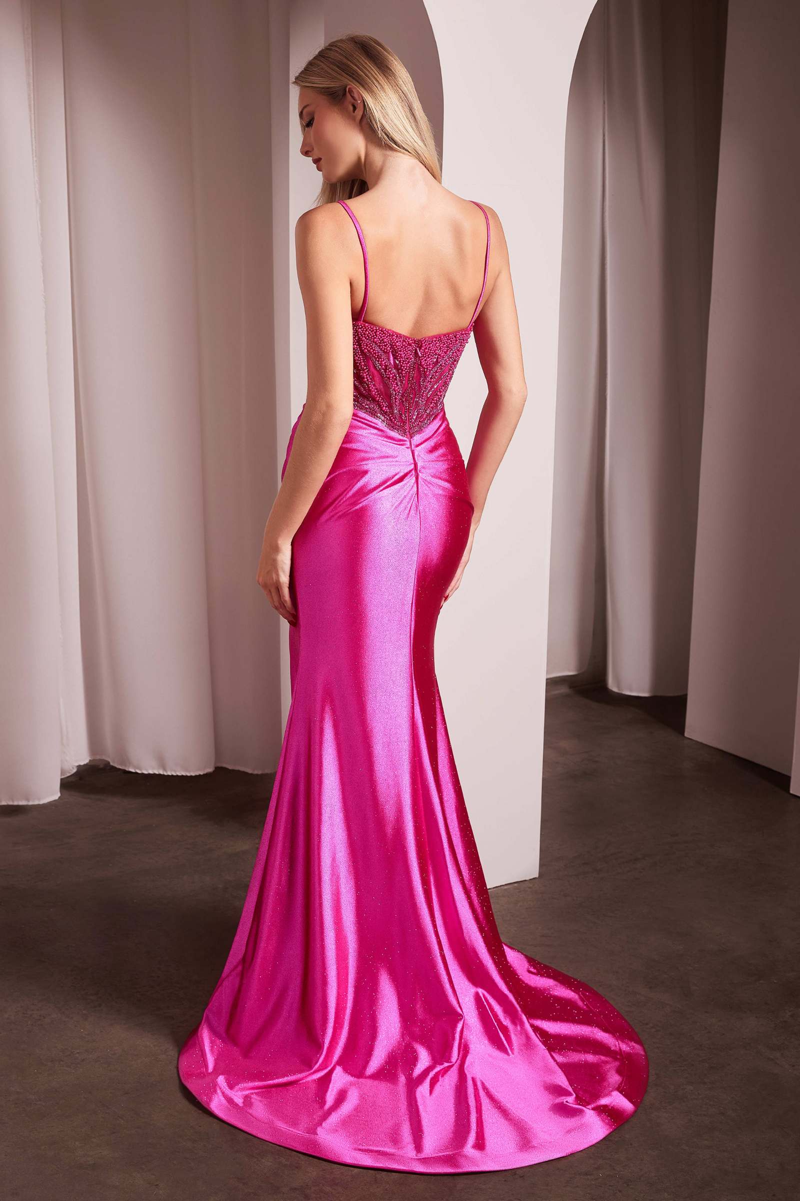 Fuchsia satin gown with open V-back, pearl-embellished detailing, thin straps, slit