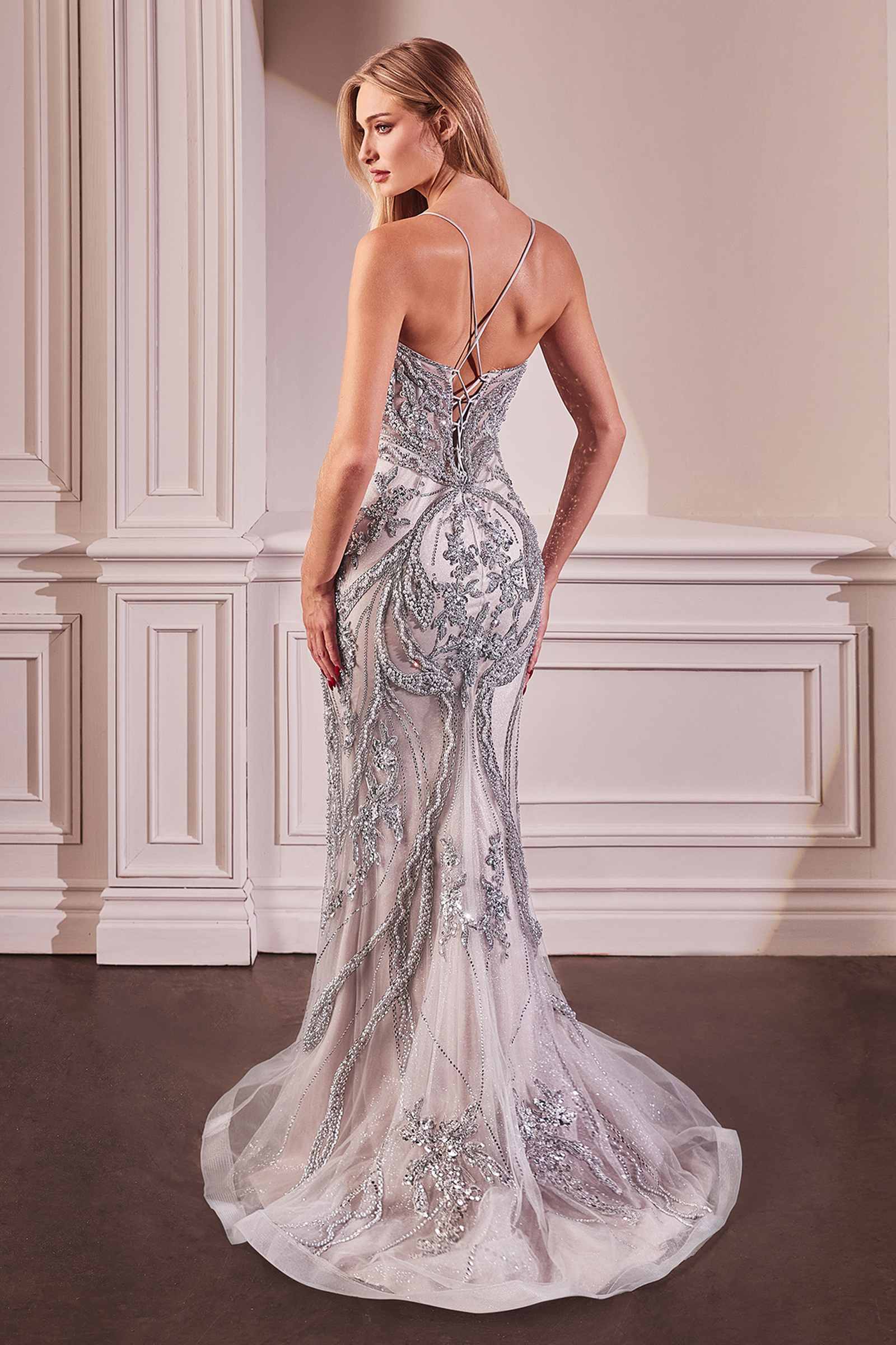 Silver pearl-embellished gown with open back, thin spaghetti straps, and fitted waist