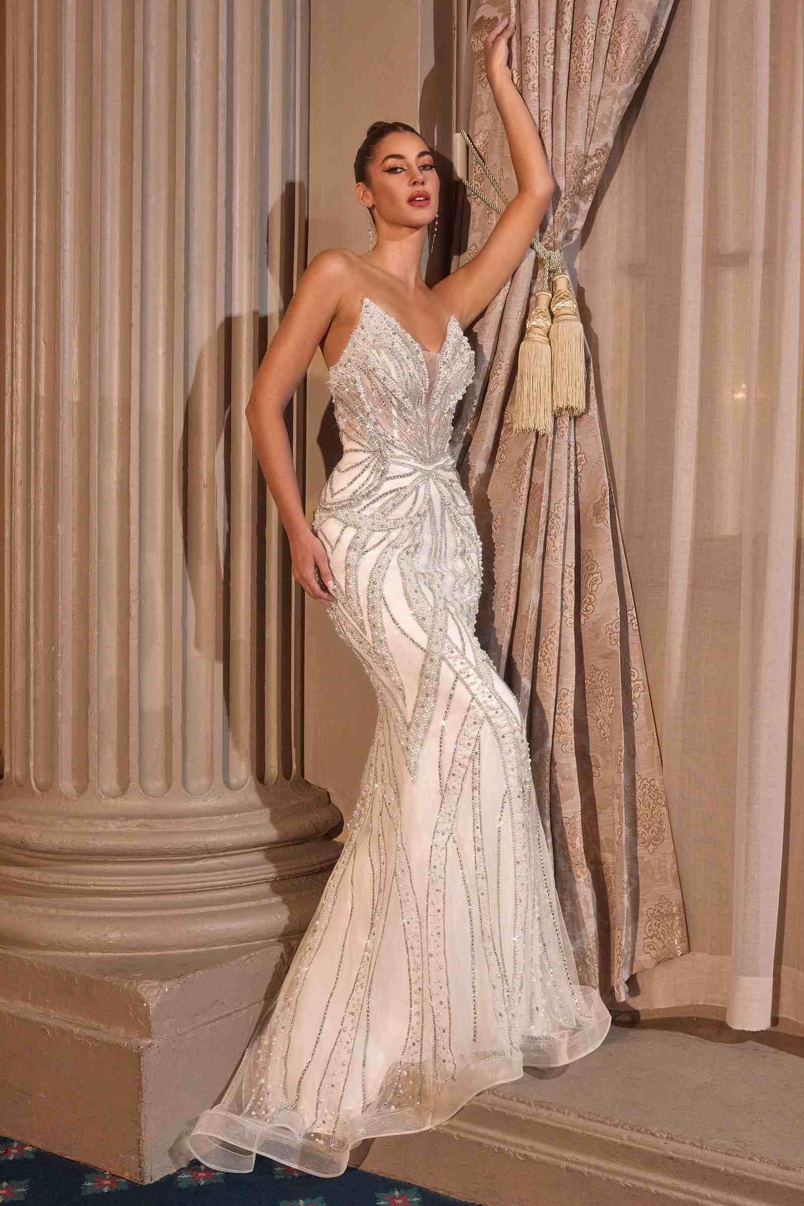 Off-white strapless fitted bridal gown with plunging neckline and beaded sparkle design