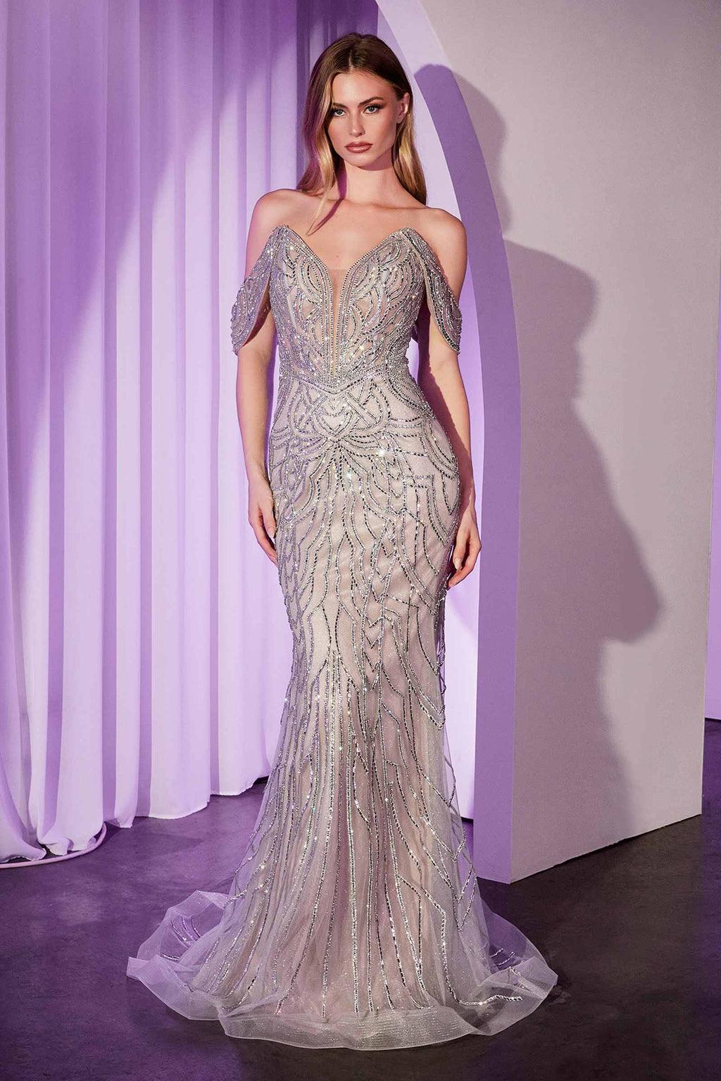 Off-shoulder crystal embellished gown in silver sequins with fitted mermaid silhouette and sheer hem