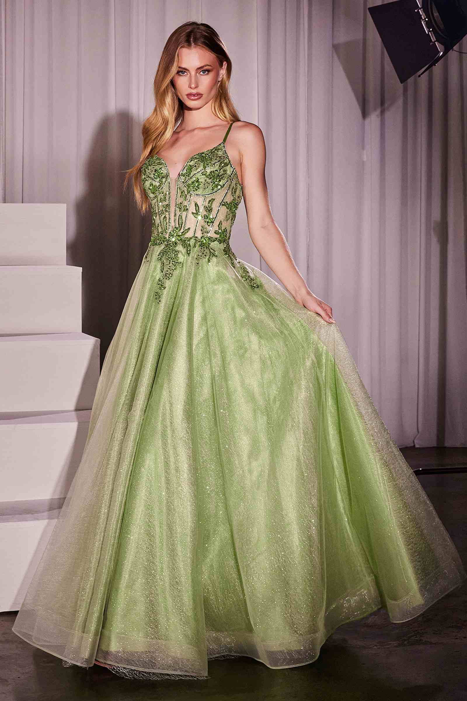Green A-line tulle gown with lace embellished bodice and thin spaghetti straps