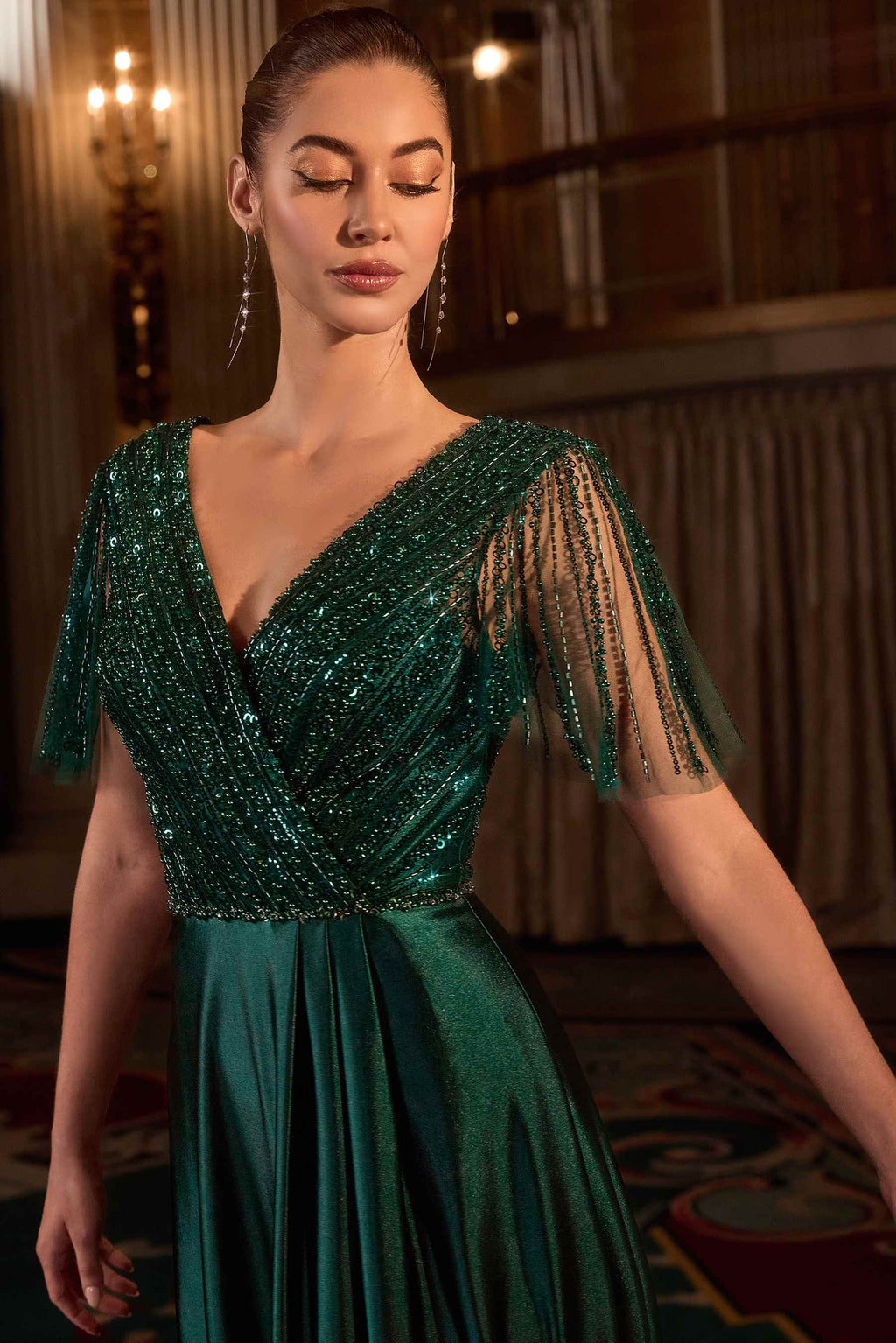 Emerald satin evening gown with V-neckline and beaded flutter sleeves