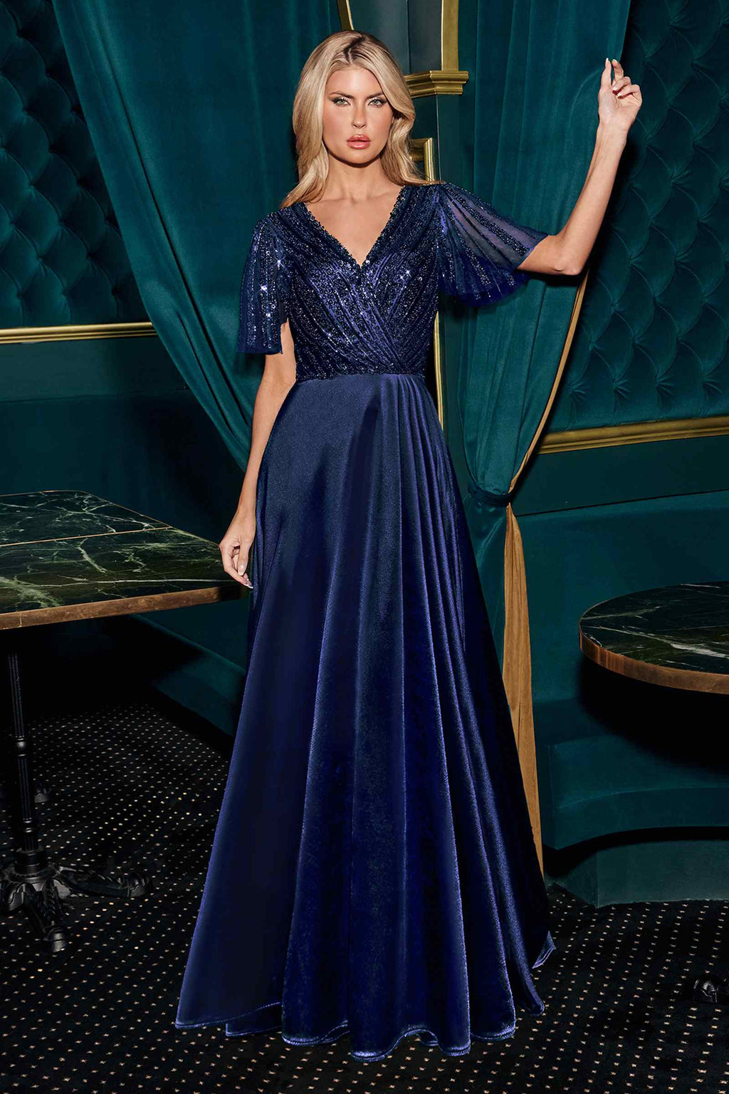Navy satin evening gown with V-neck and beaded flutter sleeves, flowing skirt