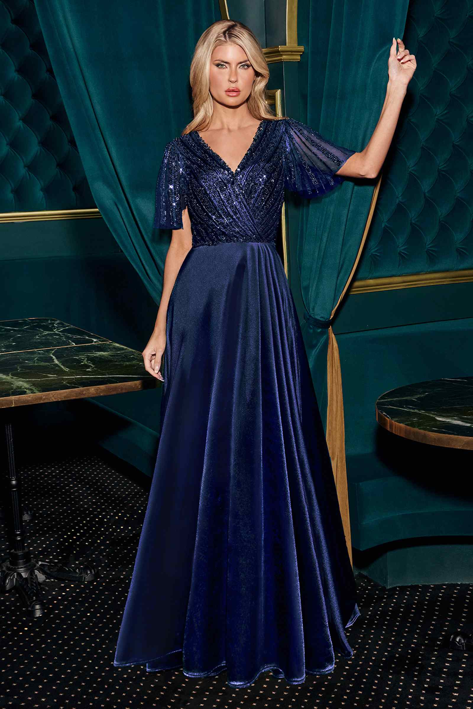 Navy satin evening gown with V-neck and beaded flutter sleeves, flowing skirt