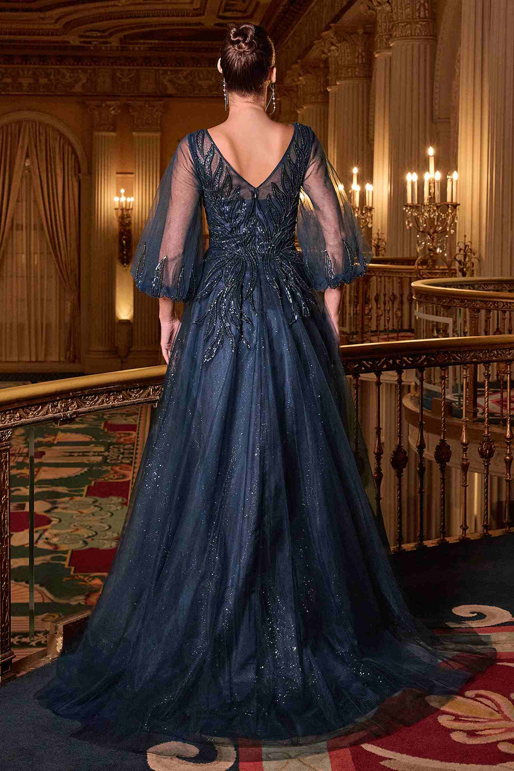 Navy blue A-line gown back view with layered tulle skirt and sheer 3/4 sleeves