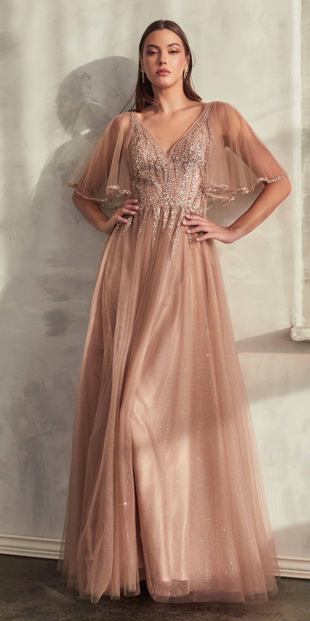 Rose gold tulle A-line gown with V-neck bodice and short sheer flutter sleeves.