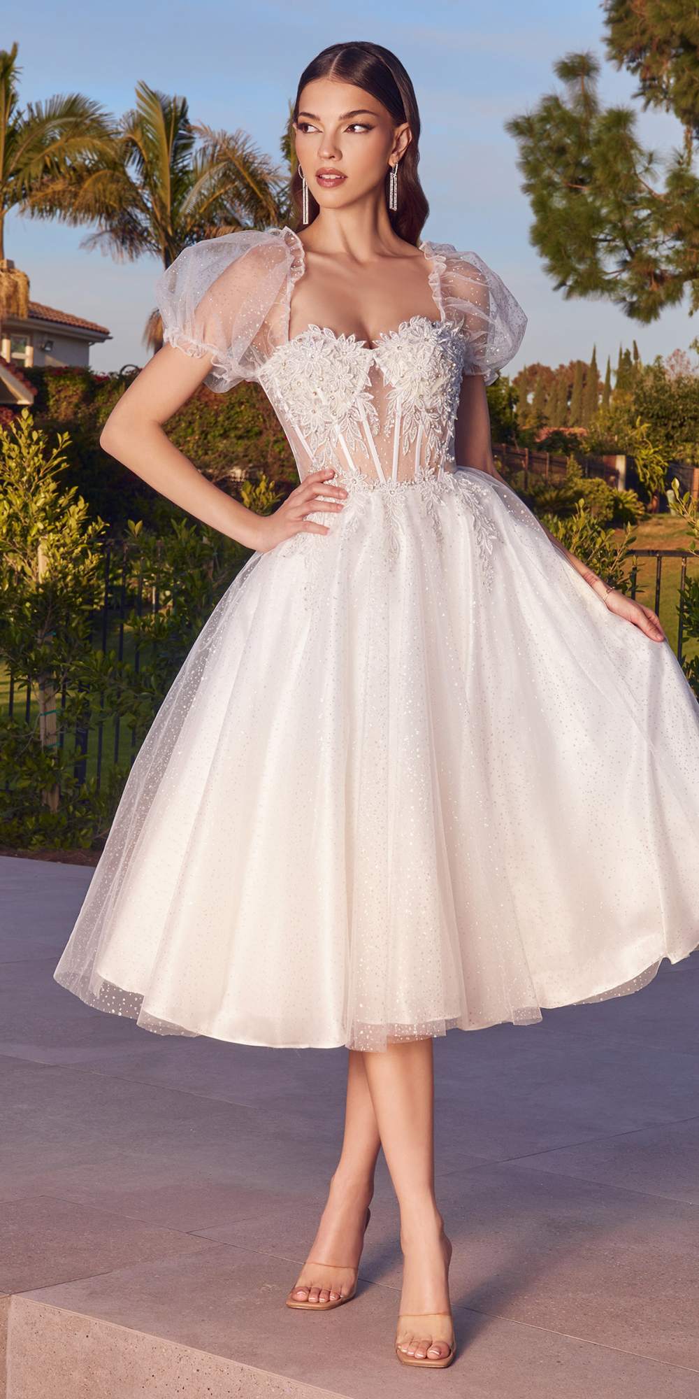 White tea-length layered tulle dress with lace bodice and short puff sleeves