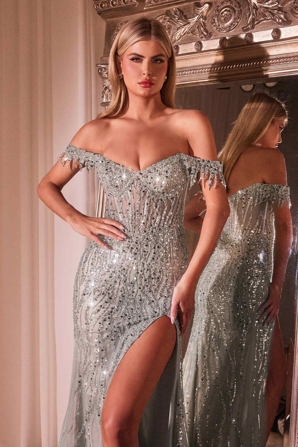 Silver off-shoulder fitted sequin gown with thigh slit and fringe trim
