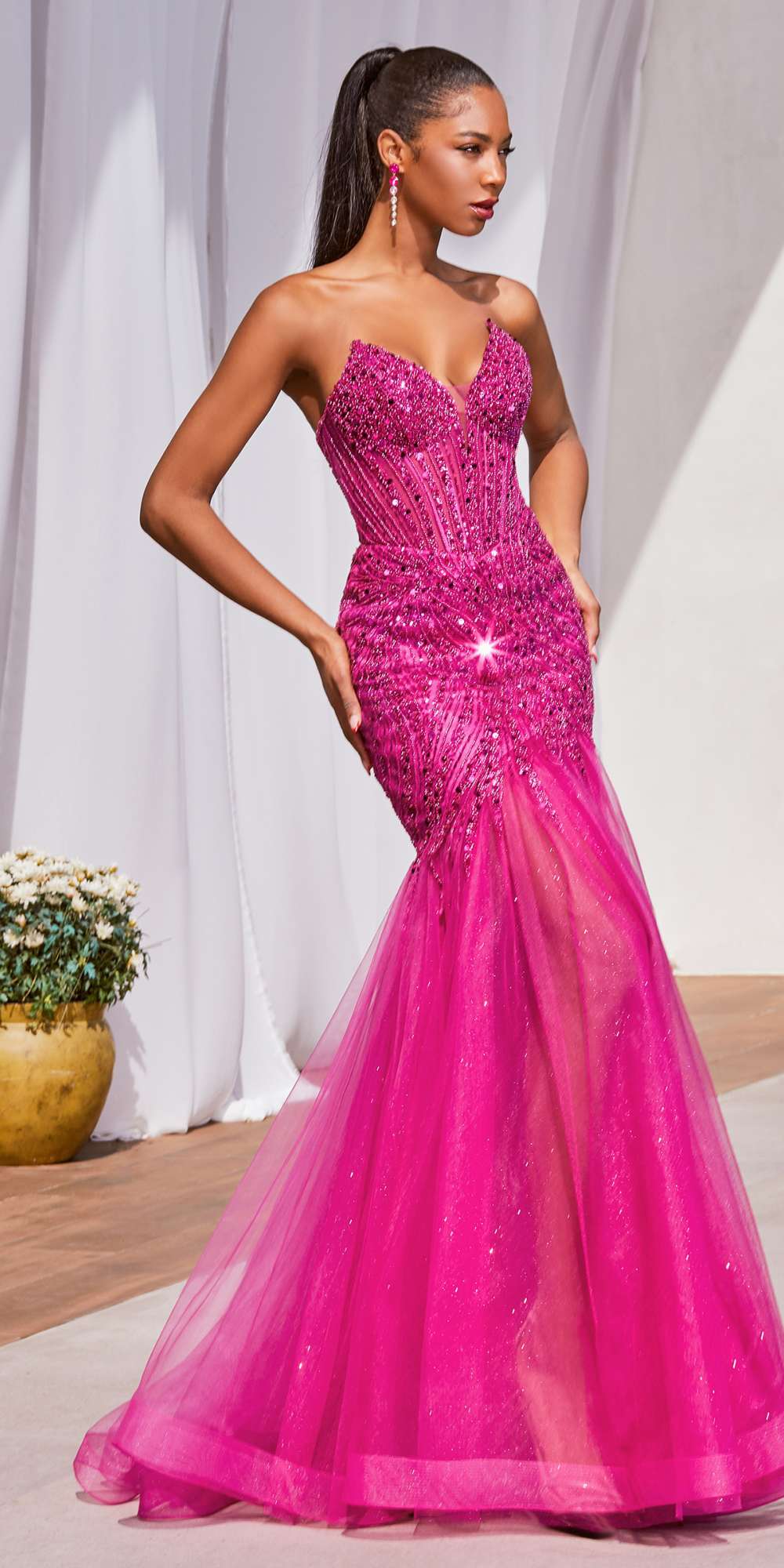 Strapless mermaid gown in magenta with beaded pointed cups and sparkling fitted corset