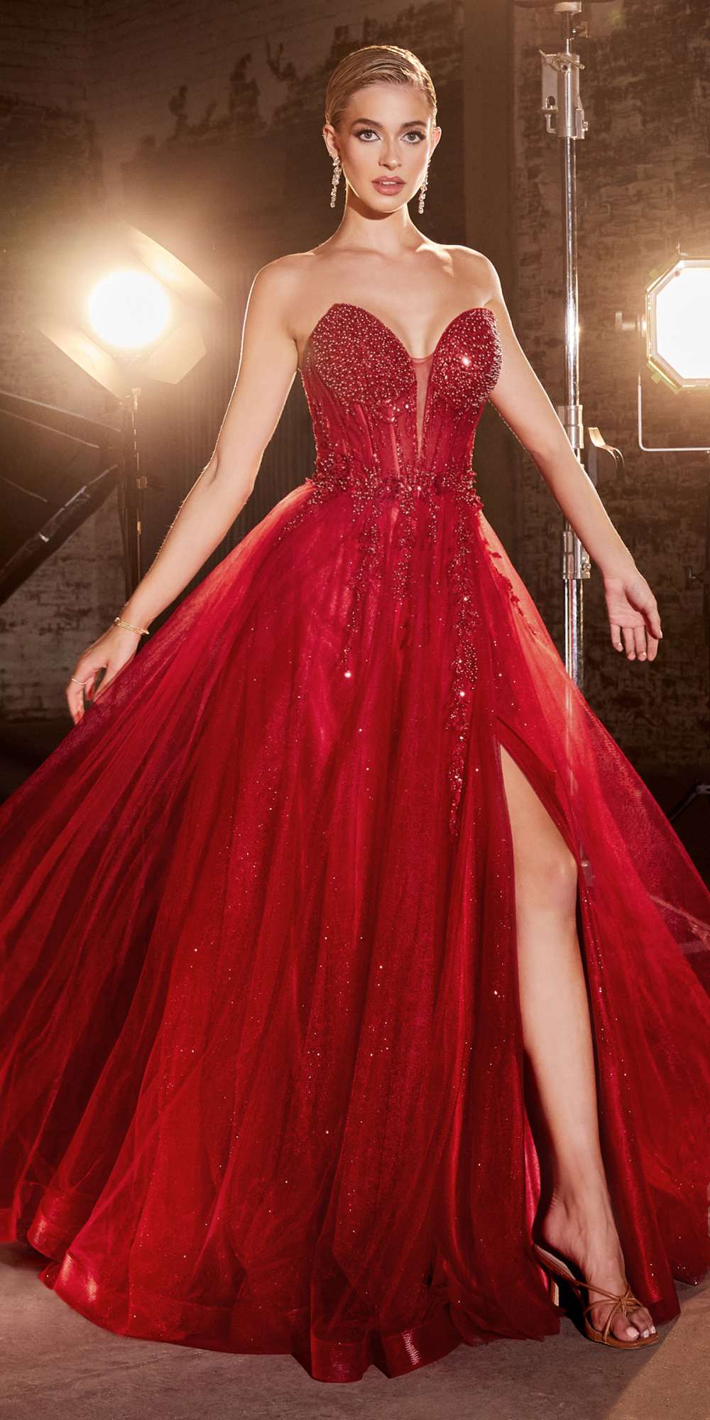 Red strapless tulle gown with beaded corset bodice and dramatic side slit