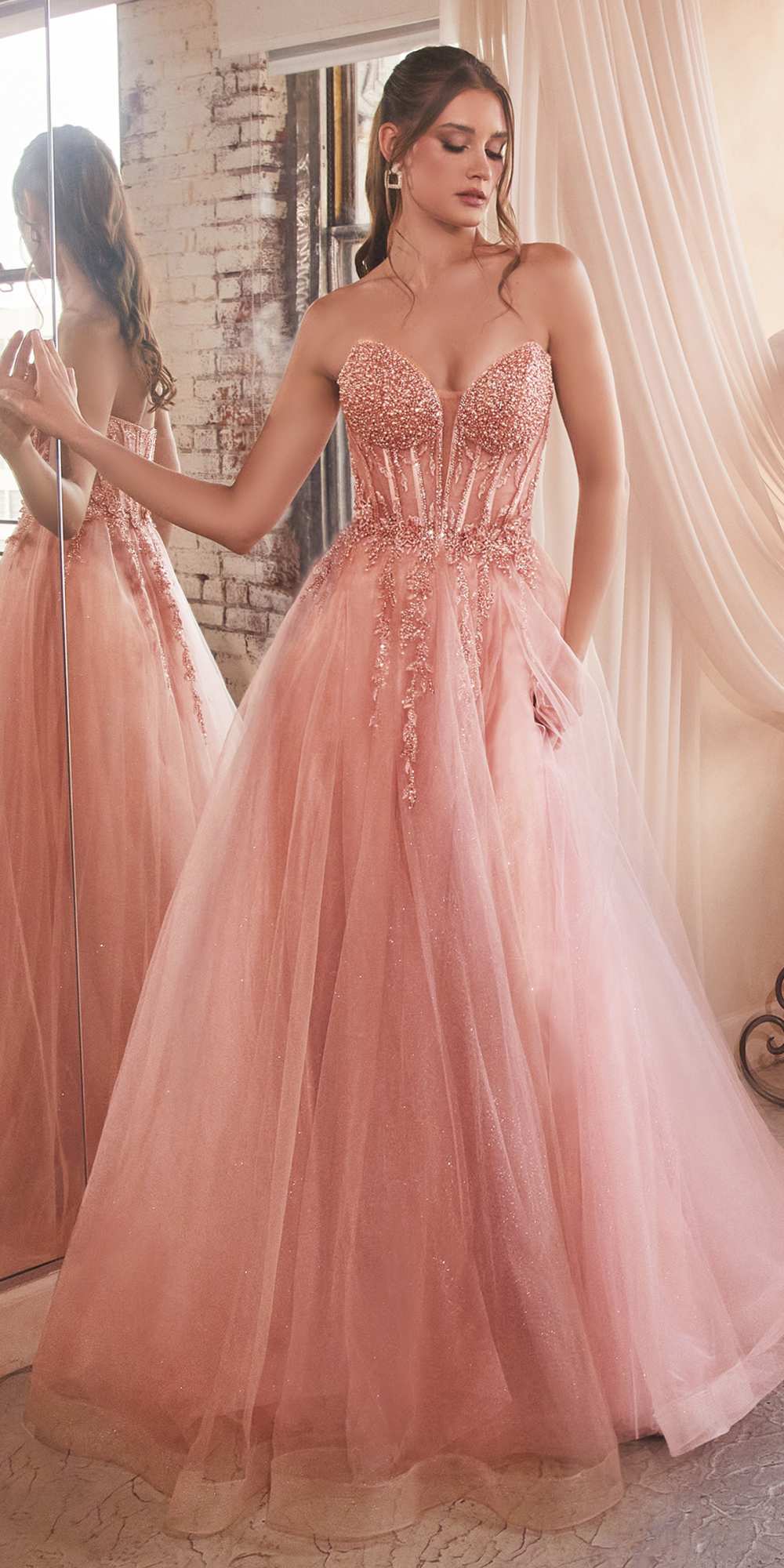 Blush pink strapless tulle ball gown with beaded corset bodice and flared skirt
