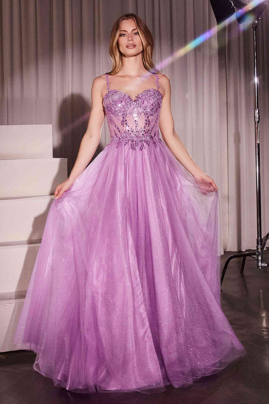 Long A-line ball gown with lace bodice, spaghetti straps, and lilac tulle skirt with slit