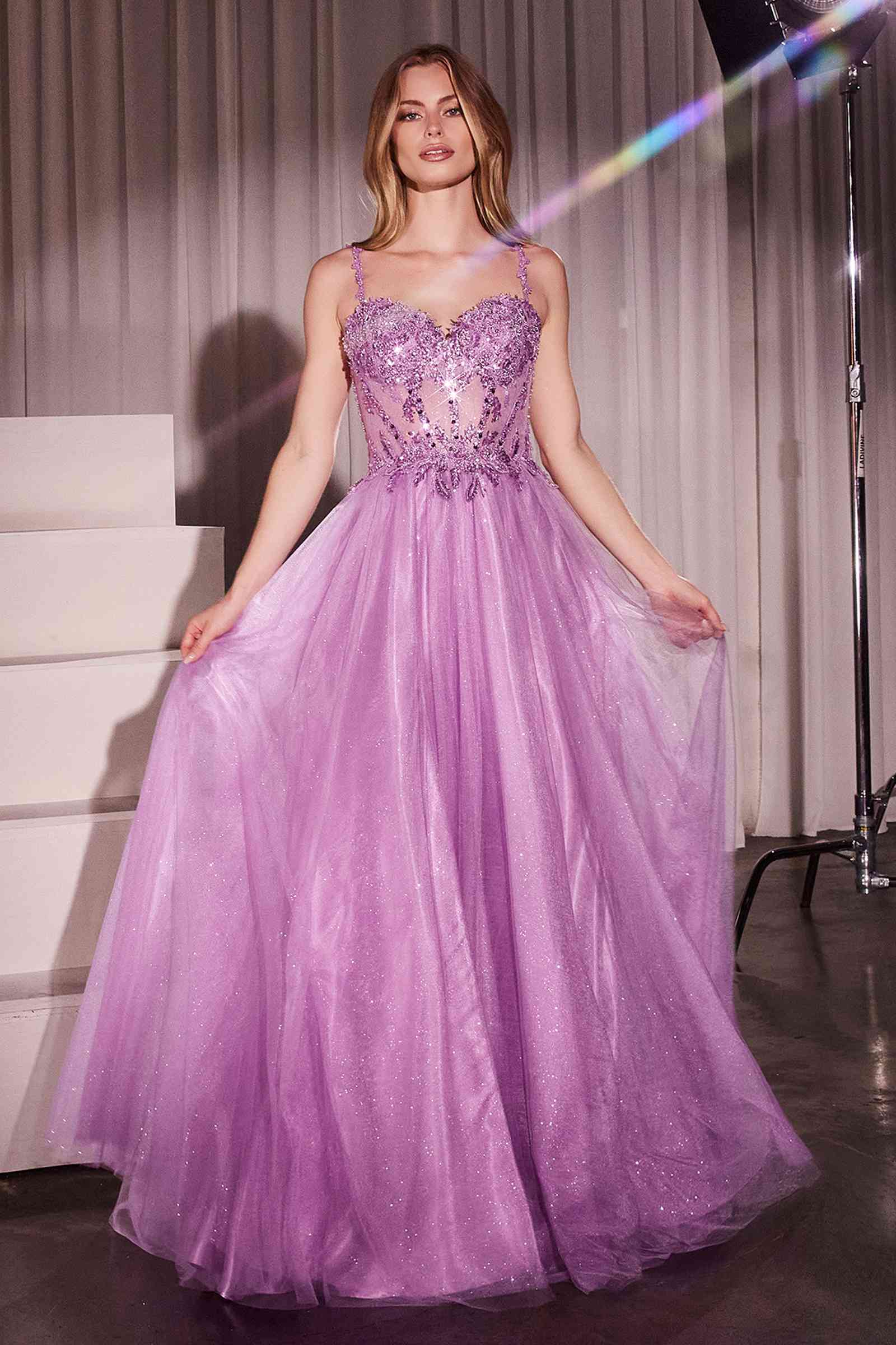 Long A-line ball gown with lace bodice, spaghetti straps, and lilac tulle skirt with slit
