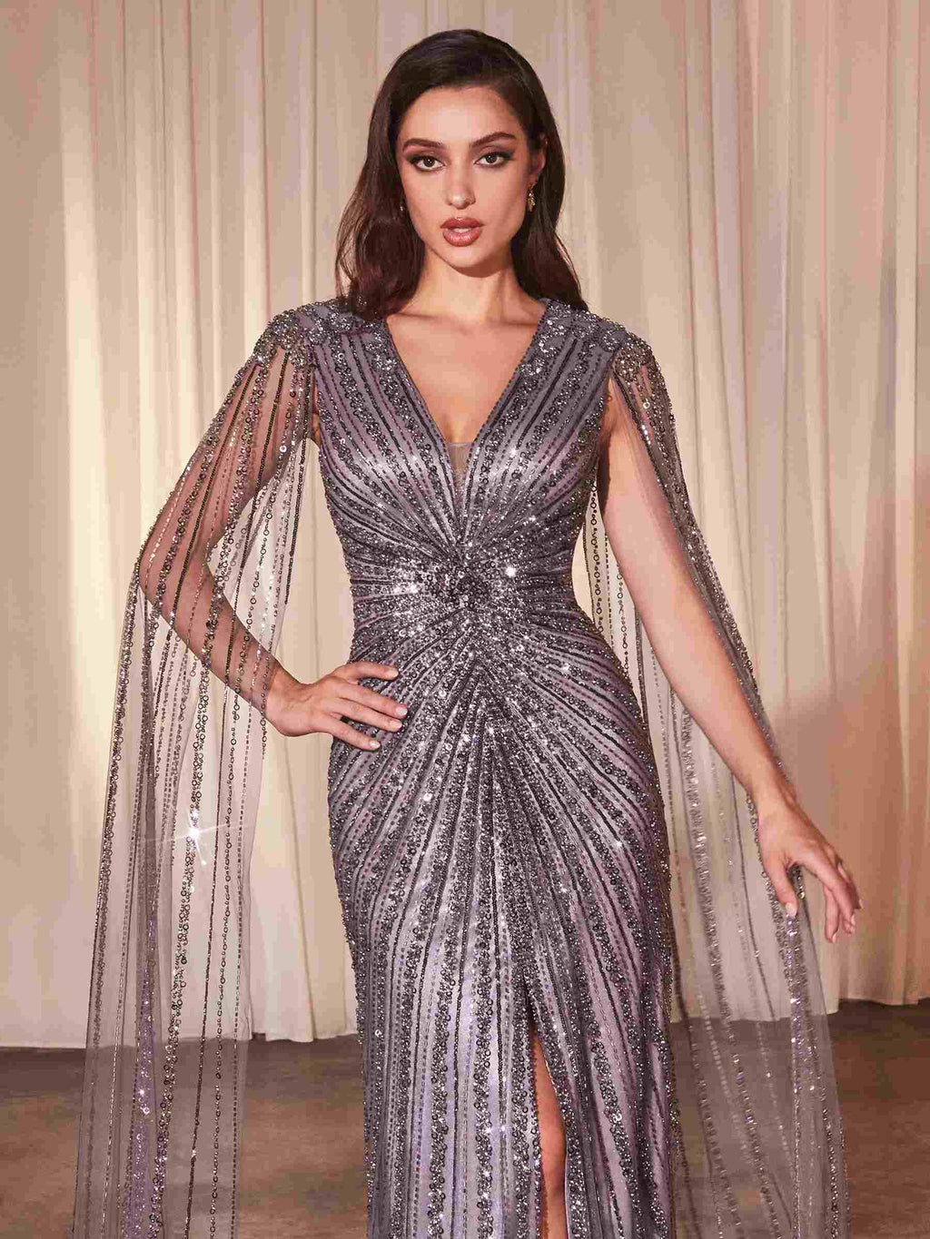 Silver beaded V-neck long-sleeve sheath gown with open neckline and cape overlay