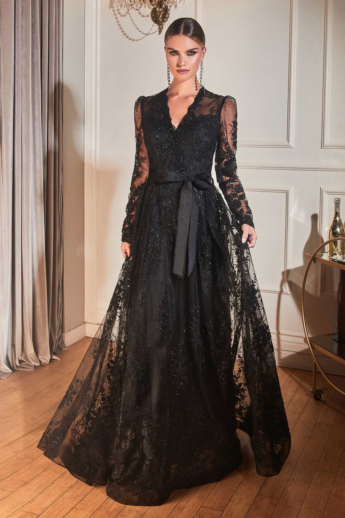 Black long-sleeve embellished ball gown with V-neck and waist tie sash at the hip