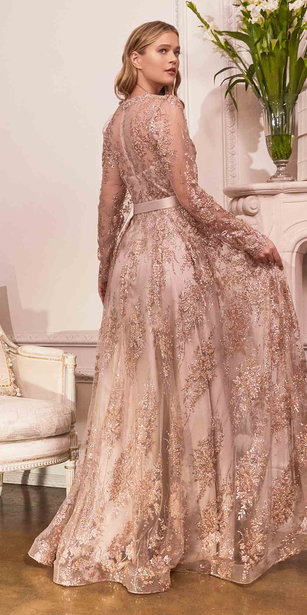 Champagne gold long-sleeve embellished ball gown with full skirt and waist tie ribbon