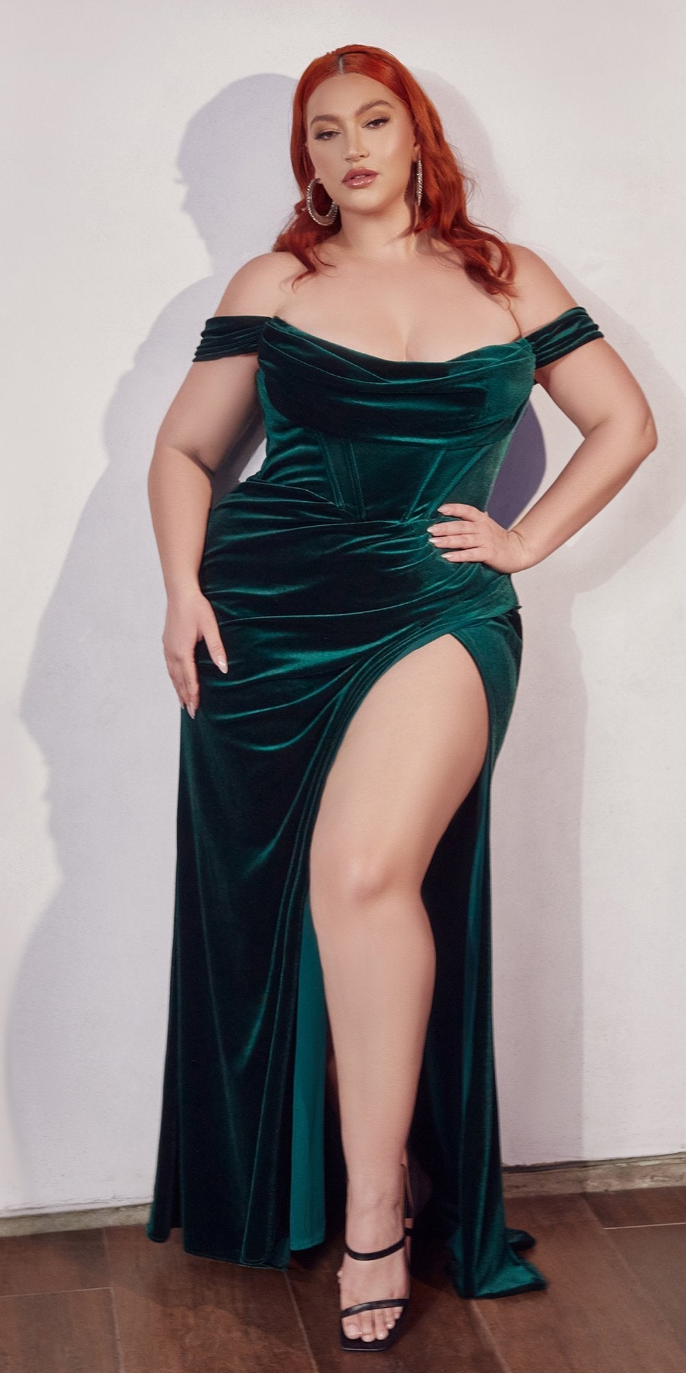 Long off-shoulder corset gown in dark green satin with draped bodice and thigh-high slit