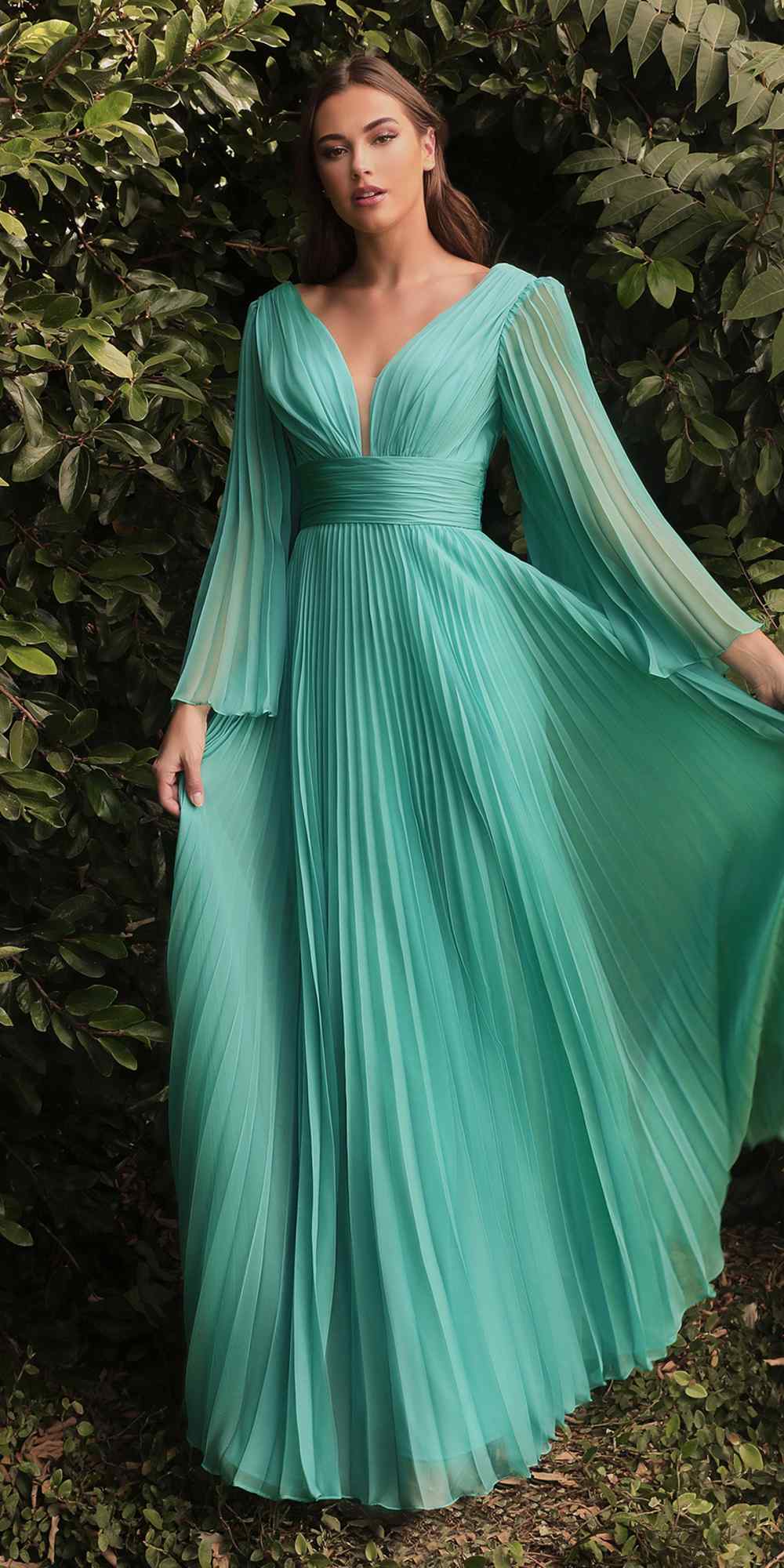 Teal pleated chiffon long sleeve gown with V-neck bodice and flowing skirt