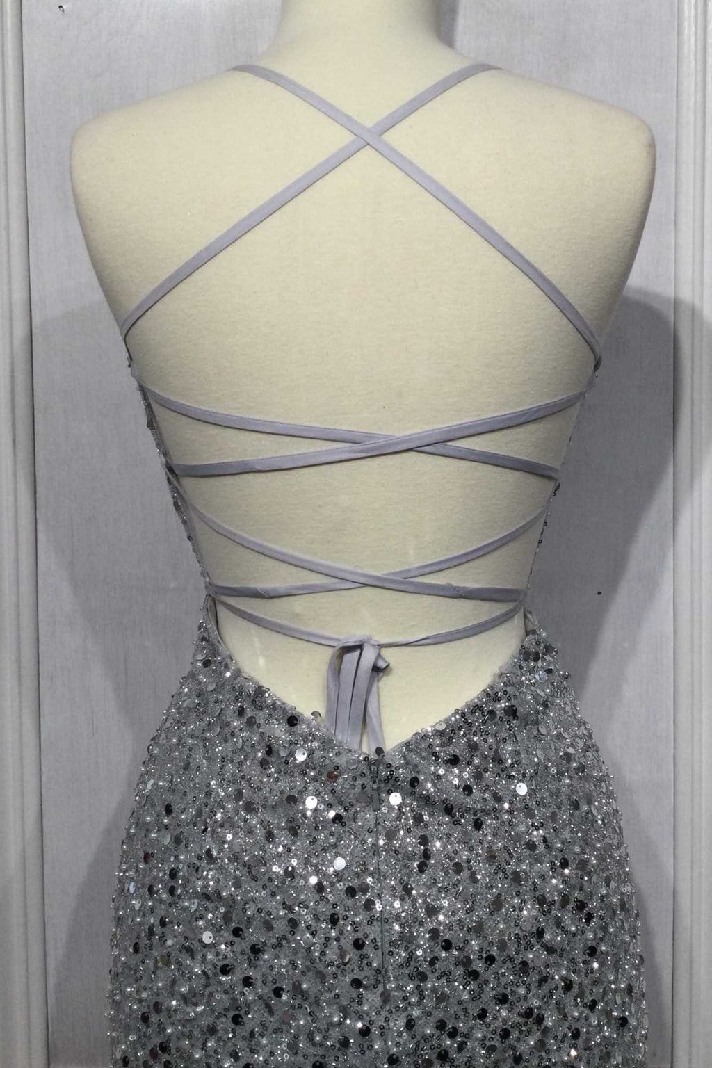 Back view of silver iridescent sequin gown with crisscross straps
