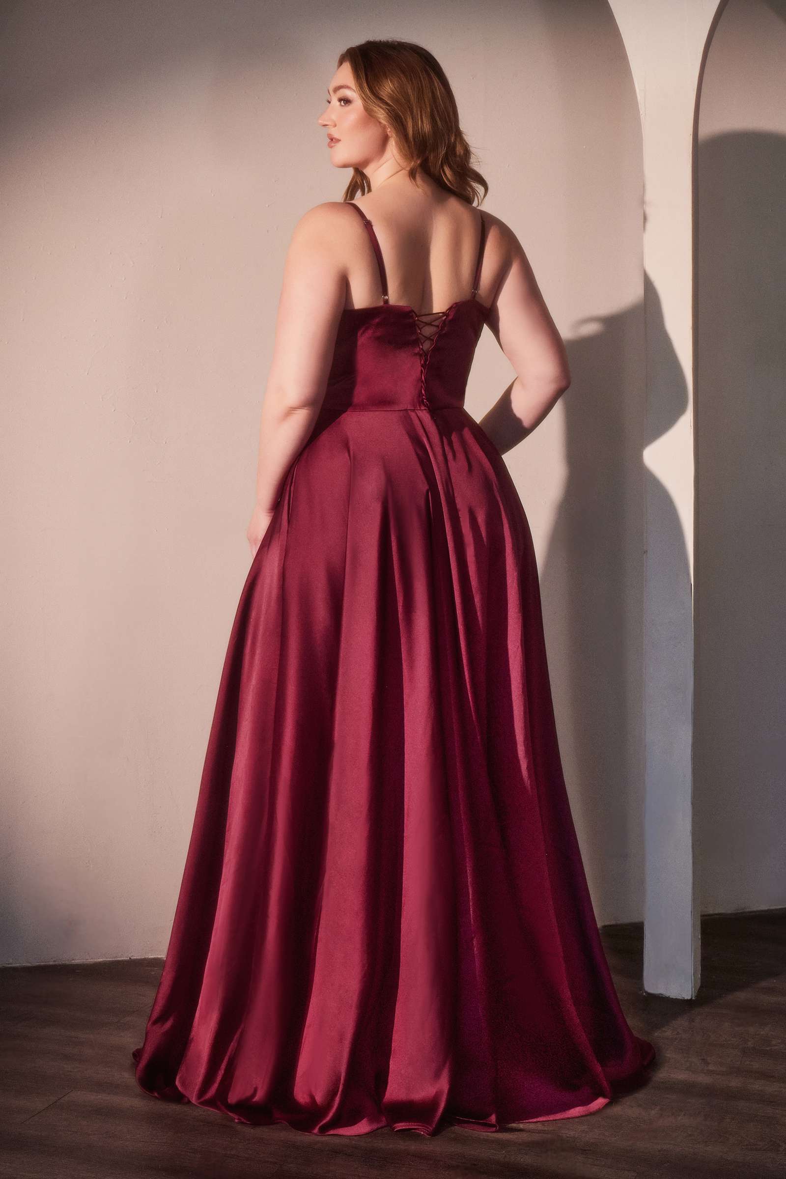 Satin long A-line prom dress with corset-style bustier, spaghetti straps, and full skirt; deep red