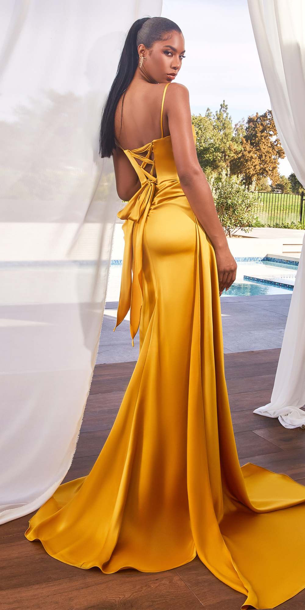 Marigold satin gown with open back, cross straps, side sash, and leg slit