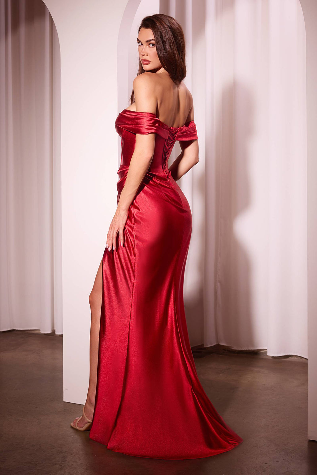 Red satin off-the-shoulder fitted gown with corset seams and side slit