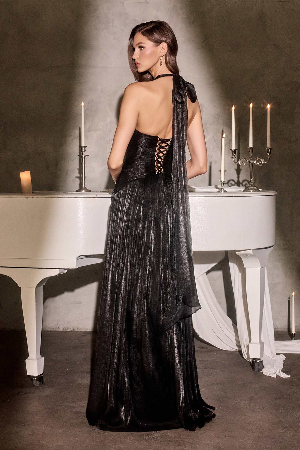Black halter gown with open back drape and flowing skirt with side slit